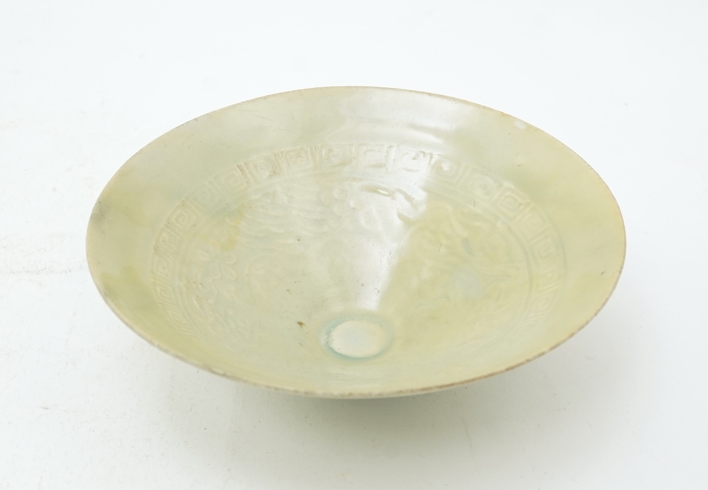 A Chinese Ding type circular dish, Song dynasty and a qingbai moulded conical bowl, Song-Yuan dynasty